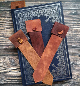 Leather bookmarks with tabs at the top in earth-toned leather.