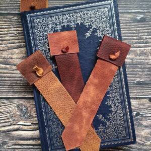 Leather bookmarks with tabs at the top in earth-toned leather.